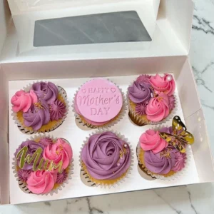Mother’s Day cupcakes with pink, orange and purple buttercream decorations in gift box